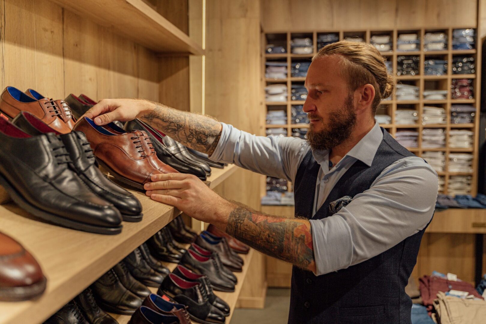 A man looking at shoes in a store.